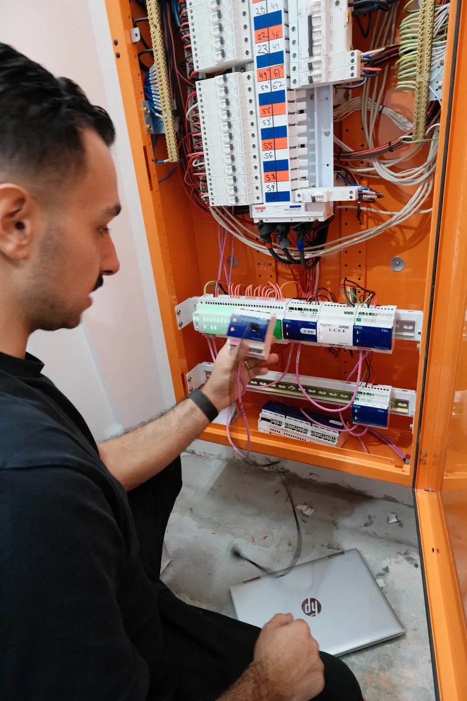 An electrician testing a switchboard in a Crows Nest apartment building