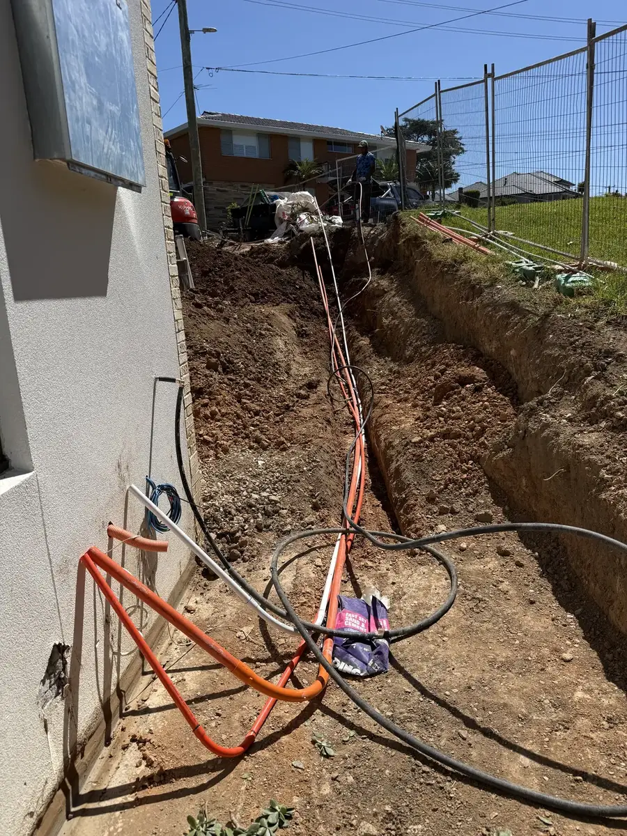 A trench being prepared for an underground electrical conduit